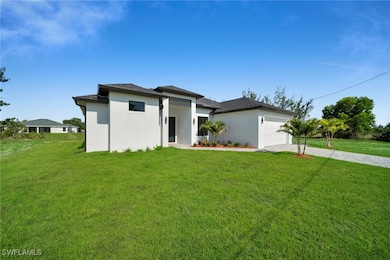 Prairie-style house with driveway, an attached gar