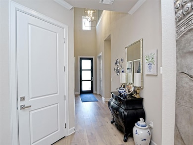 Entryway with a chandelier, plenty of natural lig