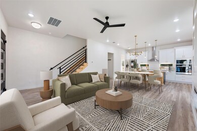 Living room with a ceiling fan, a chandelier, rec