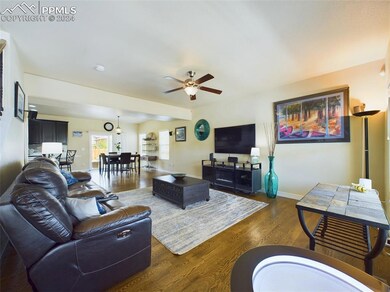 Living room with wood flooring and ceiling fan