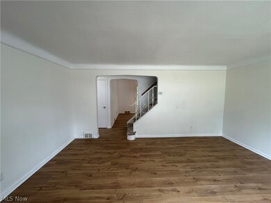 Empty room featuring dark hardwood / wood-style floors