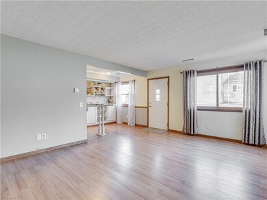 Bright living room with wood look laminate and ope