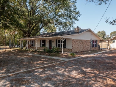 Ranch-style home featuring a chimney, brick siding