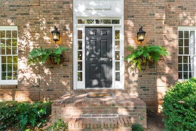 Entrance to property featuring brick siding