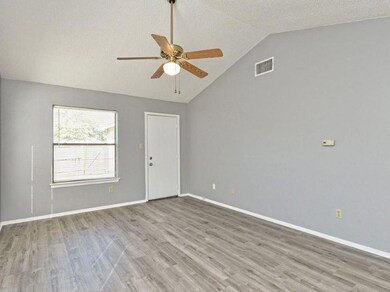 Empty room with ceiling fan, lofted ceiling, wood