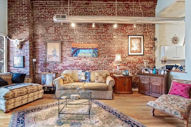 Living room with light wood-type flooring, a tower