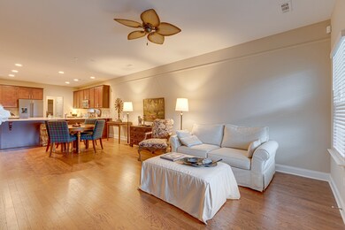 Gleaming hardwood floors and natural wood cabinets in the kitchen add warmth to the space.