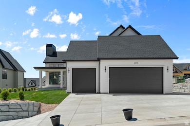 View of front of house with a shingled roof, a chimney, an attached garage, driveway, and a porch