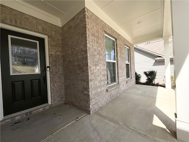 View of exterior entry featuring brick siding and 