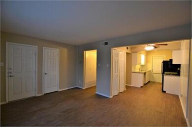 Unfurnished living room featuring ceiling fan and 