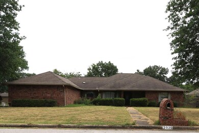 Single story home featuring a front lawn