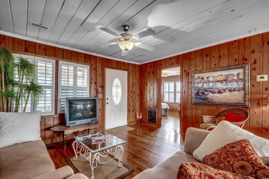 Living room featuring crown molding, wood walls, c