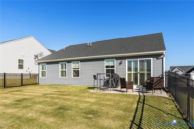 Rear view of house with a fenced backyard, a patio, and a shingled roof
