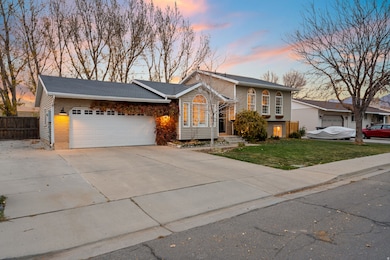 View of front of property featuring driveway, an attached garage, and brick siding