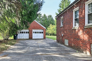 View of detached garage & side of home *view down driveway from front of property*