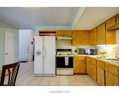 Kitchen. With access to the back, this tile kitchen sports ample cabinet space, with undermount lighting, and a breakfast area perfect for that morning cup of coffee.