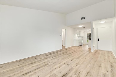 Unfurnished living room featuring light wood-styl