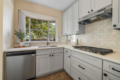 Kitchen with stainless steel appliances, exhaust 