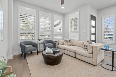 Living room with hardwood / wood-style flooring an