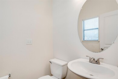 Half bathroom featuring toilet and a sink