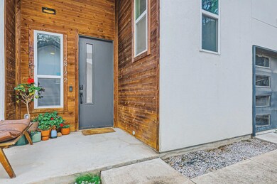 Entrance to property featuring stucco siding