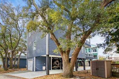 View of front of home with a shed, an attached garage, and concrete driveway