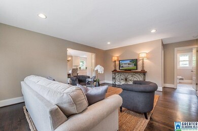 Large family room with beautiful hardwood floors a