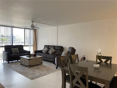Living room featuring a ceiling fan and floor to c