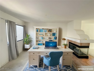 Office space featuring a tiled fireplace