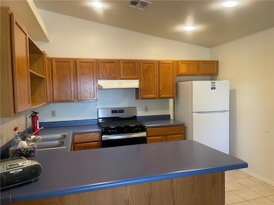 Kitchen featuring gas range, under cabinet range h