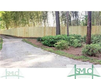 Yard/Garden. Landscaping and fence along driveway.