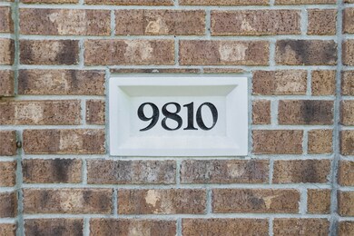 Close-up of the home’s address plate—9810—cleanly