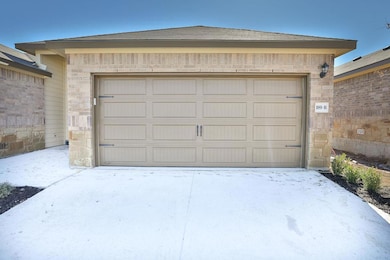 Garage featuring concrete driveway