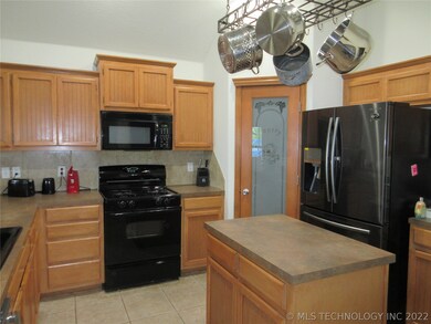 Open kitchen with island. Pantry. Tile floors.