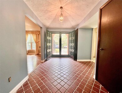 Foyer: dining room to the left, living room to the right. Two closets flank the entrance to the living room.