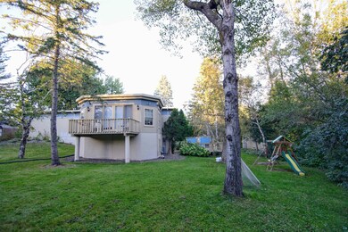 View of yard with a deck and a playground facing m