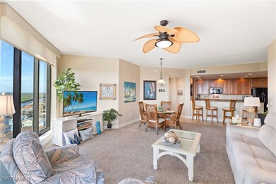 Living room with baseboards, a ceiling fan, visibl