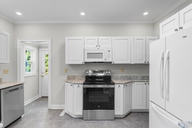Kitchen featuring stainless steel appliances, whit