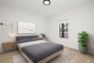 Bedroom with light wood finished floors and baseboards