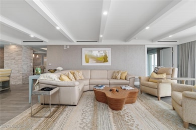 Living area featuring recessed lighting, beamed ceiling, and wood finished floors