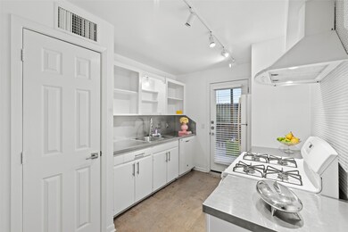 Kitchen has a gas stove with tiled backsplash that