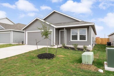 Ranch-style house with a front yard, driveway, and an attached garage
