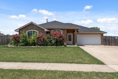 Ranch-style house featuring brick siding, drivewa