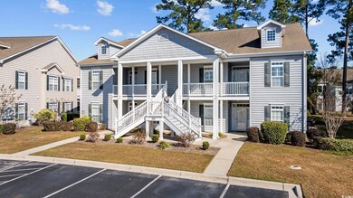 Exterior space featuring a front lawn and covered 