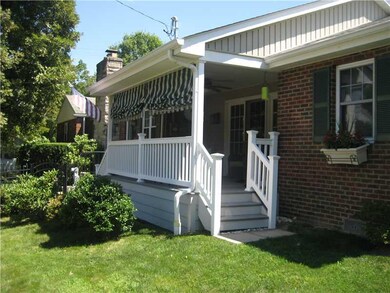 Exterior Front. Charming curb appeal, shows exterior view of the front porch and attractive plantings.