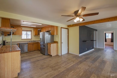 Kitchen featuring butcher block counters, healthy amount of natural light, dark wood-style flooring, and stainless steel appliances
