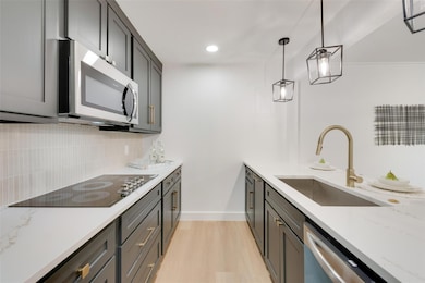Kitchen with decorative backsplash, hanging light 