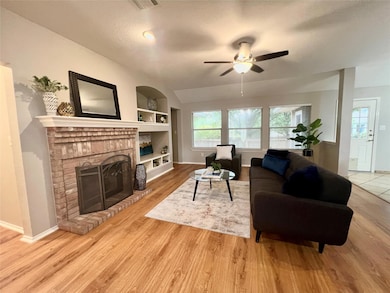 Living area featuring built in features, a brick 