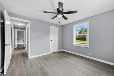 Unfurnished bedroom featuring a closet, hardwood / wood-style floors, and ceiling fan