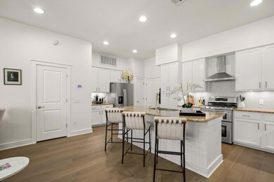 Kitchen with wall chimney range hood, stainless s